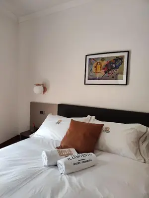 Letto o letti in una camera di Palazzo il Convento Universita