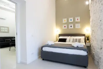 Letto o letti in una camera di GuestHost - Suite I Miracoli Central Apartment