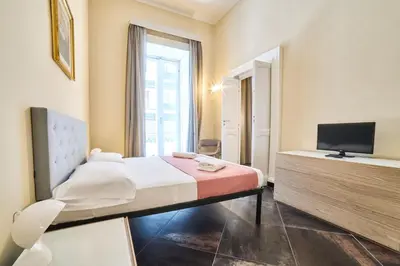 Letto o letti in una camera di Via Niccolò Tommaseo 14