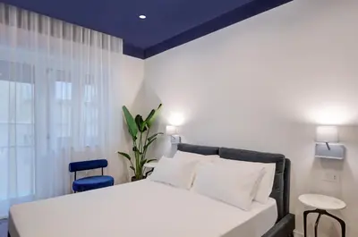 Letto o letti in una camera di Well Suites - Piazza dei Martiri