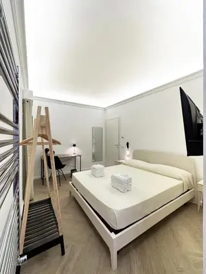 Letto o letti in una camera di VICKI Vomero Rooms - Napoli