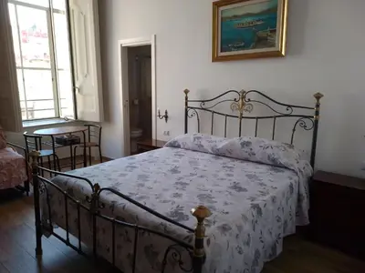 Letto o letti in una camera di B&B Palazzo Sersale Napoli