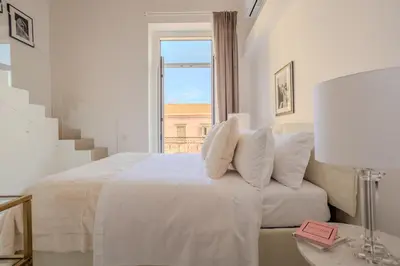 Letto o letti in una camera di La Corte dei Mille Luxury
