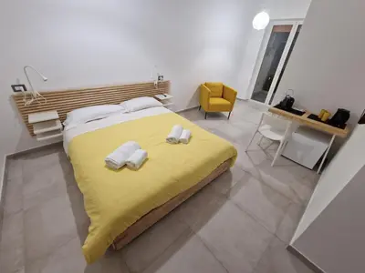 Letto o letti in una camera di Neapolitan Skyscraper Suites