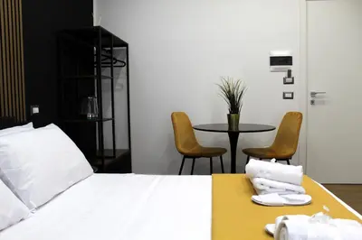 Letto o letti in una camera di BlackWoody Contemporary Rooms - Napoli Centro Storico
