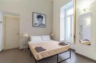 Letto o letti in una camera di Napoli Relax Rooms Chiaia - Mergellina - Posillipo