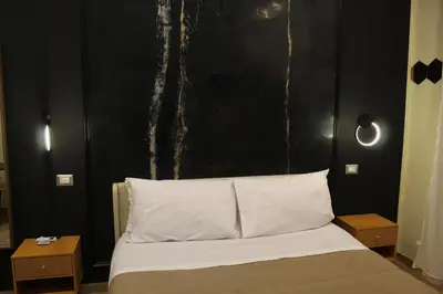 Letto o letti in una camera di BlackWoody Contemporary Rooms - Napoli Centro Storico Via Toledo