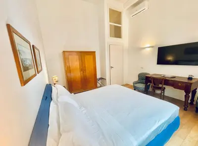 Letto o letti in una camera di ALMA de Partenope - Relais de Charme by the sea