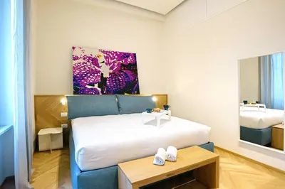 Letto o letti in una camera di Real Passeggio Guest House - Dimore Partenopee