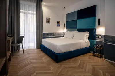 Letto o letti in una camera di Hotiday Napoli Vittorio Emanuele