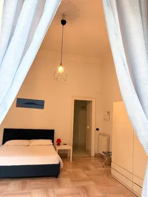 Letto o letti in una camera di Residenza Castel dell'Ovo