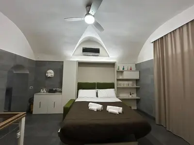 Letto o letti in una camera di Suite Contè Mezzocannone