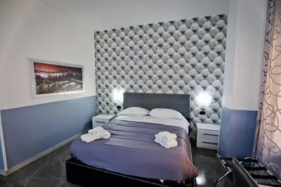 Letto o letti in una camera di BeB Napoli la perla