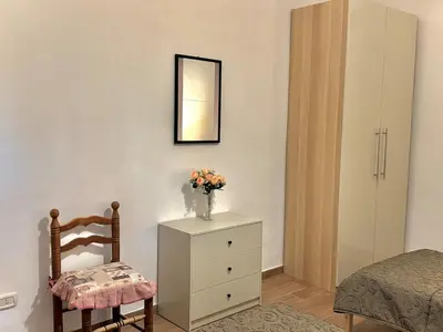 Letto o letti in una camera di La Casa di Bijou a Napoli Materdei con giardino