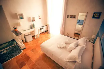 Letto o letti in una camera di NapoliMia Boutique Hotel