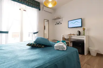 Letto o letti in una camera di Napolilive B&B
