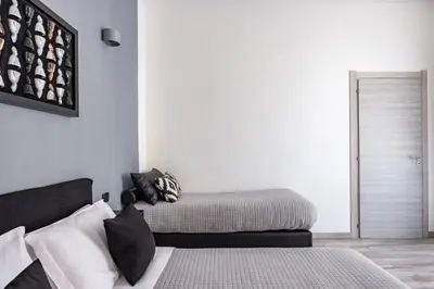Letto o letti in una camera di Palazzo Mormando - Modern Apartment