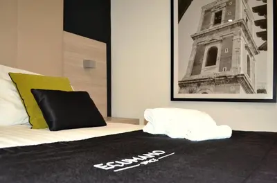 Letto o letti in una camera di Ecumano Space