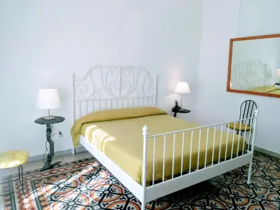 Letto o letti in una camera di L'Atelier Vedi Napoli ai tuoi piedi