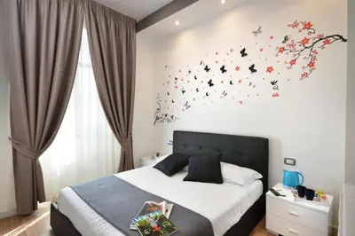Letto o letti in una camera di B&BCentral Station Napoli