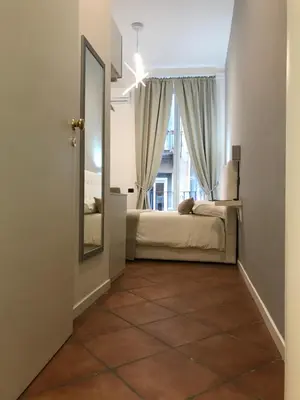 Letto o letti in una camera di Base Napoli Plebiscito