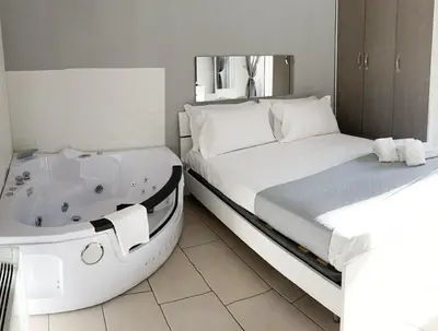 Letto o letti in una camera di De Gasperi House- Elegante appartamento,con terrazza,nel cuore di Napoli