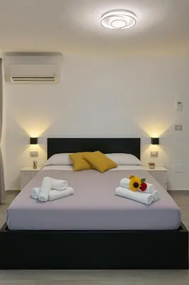 Letto o letti in una camera di NAPOLI VIBES Rooms