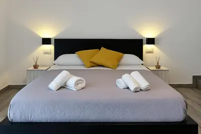 Letto o letti in una camera di NAPOLI VIBES Rooms