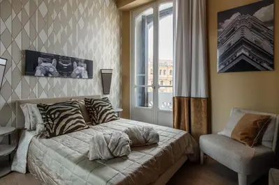Letto o letti in una camera di Palazzo Nanà Suites & Apartments
