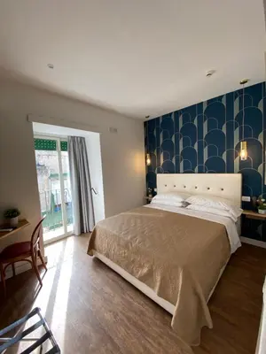 Letto o letti in una camera di Hotel Europeo Napoli