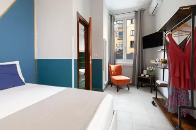 Letto o letti in una camera di ROYAL ROOMS STATION NAPOLI