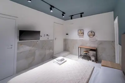 Letto o letti in una camera di P.C. Boutique H. De Gasperi, Napoli Centro, by ClaPa Group