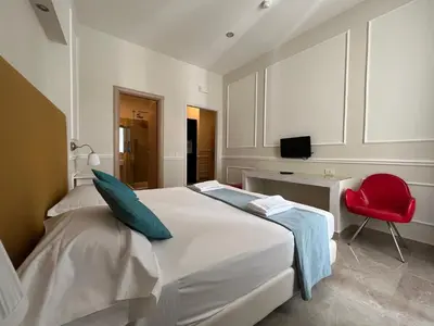 Letto o letti in una camera di Napolit'amo Hotel Principe