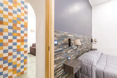 Letto o letti in una camera di Gelso Complex Studios and Flat by Napoliapartments