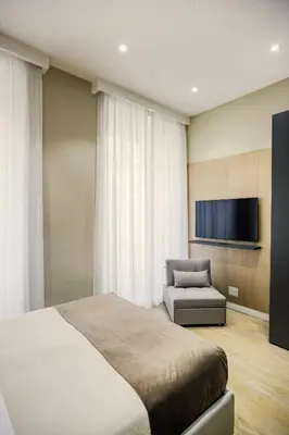 Letto o letti in una camera di PIAZZA AMORE NAPOLI LUXURY APARTMENT nel cuore di Napoli
